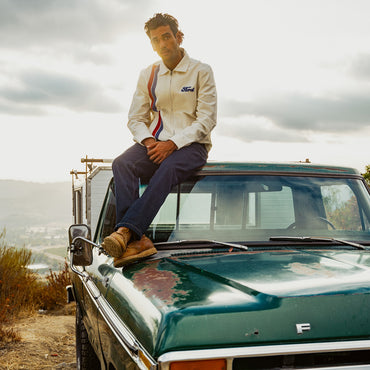 Man in white racing jacket on ford bronco
