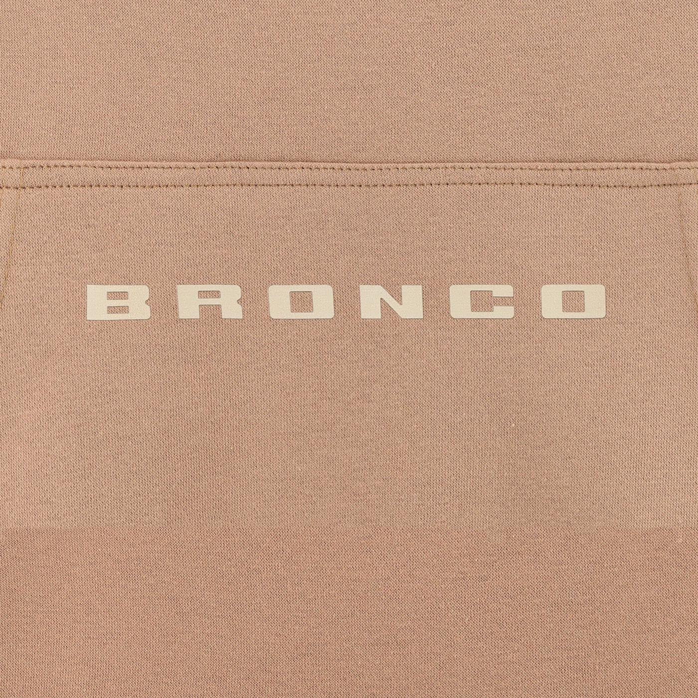 Close-up of a brown fabric surface with 'BRONCO' branding.