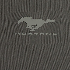 A close-up of a dark gray textured fabric featuring the embossed silver Mustang logo and the word 'MUSTANG' underneath.