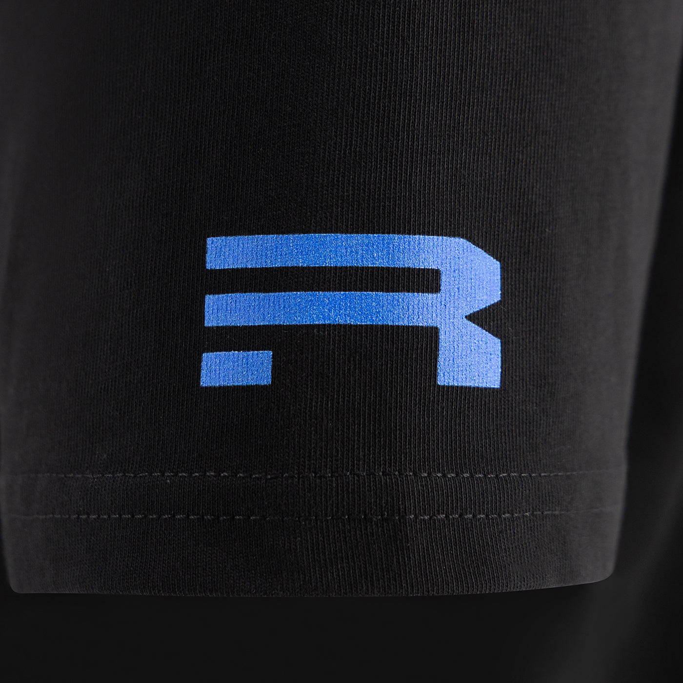 Black t-shirt with a blue Ford Racing logo on a black t shirt sleeve