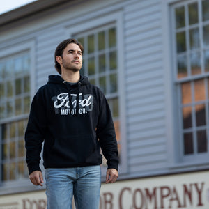 man outside wearing a black hoodie with white Ford motor co script text