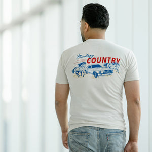 man wearing a mustang country graphic ream t-shirt on a white background