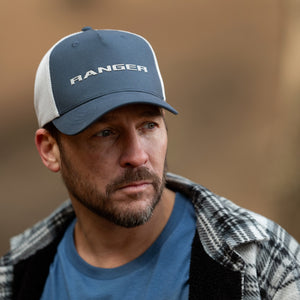 Man wearing a cap with 'RANGER' branding against a blurred background