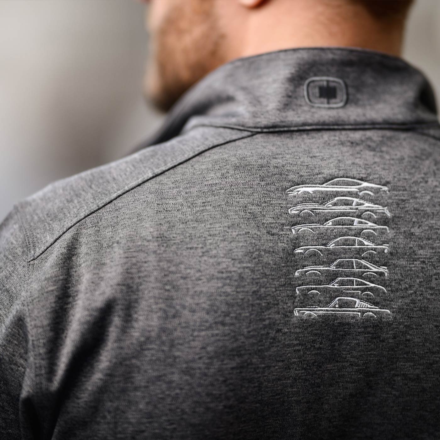 back of a mustang gray quarter zip pullover with mustang vehicles in six versions embroidered under back collar