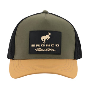 An olive green and tan trucker hat with black mesh side panels, featuring a black front patch with a tan bucking horse logo and the text 'BRONCO Since 1966'.