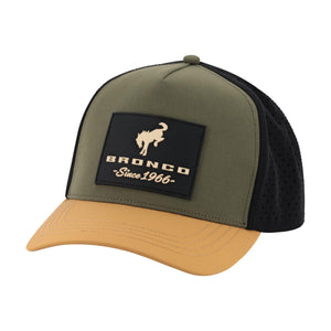 A trucker-style cap with an olive green front panel, black mesh back, and a tan curved brim. It features a black rectangular patch on the front with a tan bronco logo and the text 'BRONCO Since 1966'.