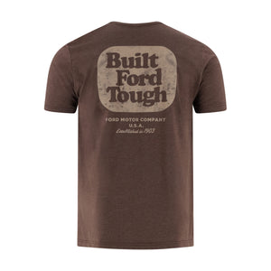 A brown short-sleeve t-shirt shown from the back, featuring a distressed beige graphic that reads 'Built Ford Tough' with 'FORD MOTOR COMPANY U.S.