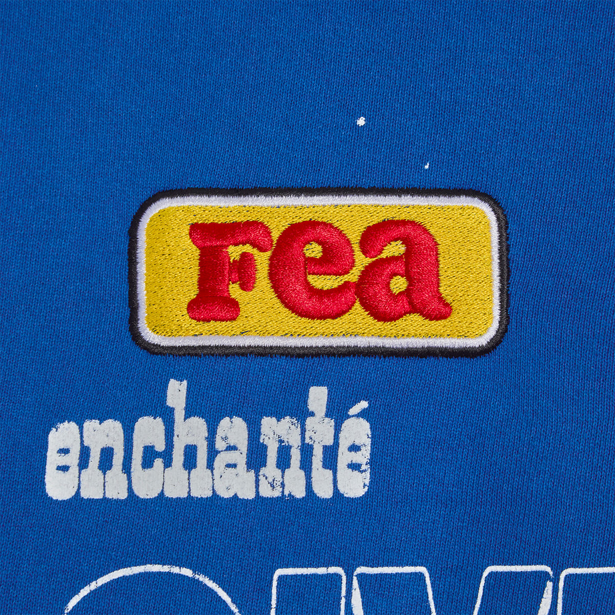 FEA yellow patch with enchante text on a blue background