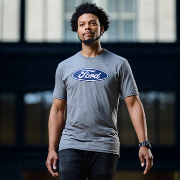 Man wearing a gray Ford t-shirt in an indoor setting