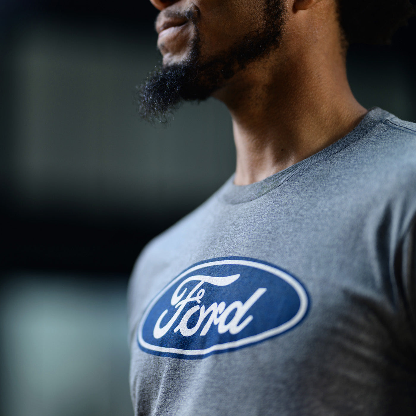 Person wearing a gray t-shirt with a Ford logo