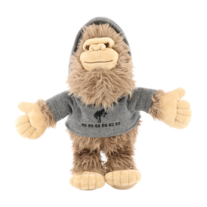 Plush toy resembling a sasquatch wearing a gray hoodie with 'Bronco' branding on a white background