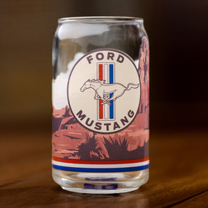 Glass can with Ford Mustang logo on a wooden surface