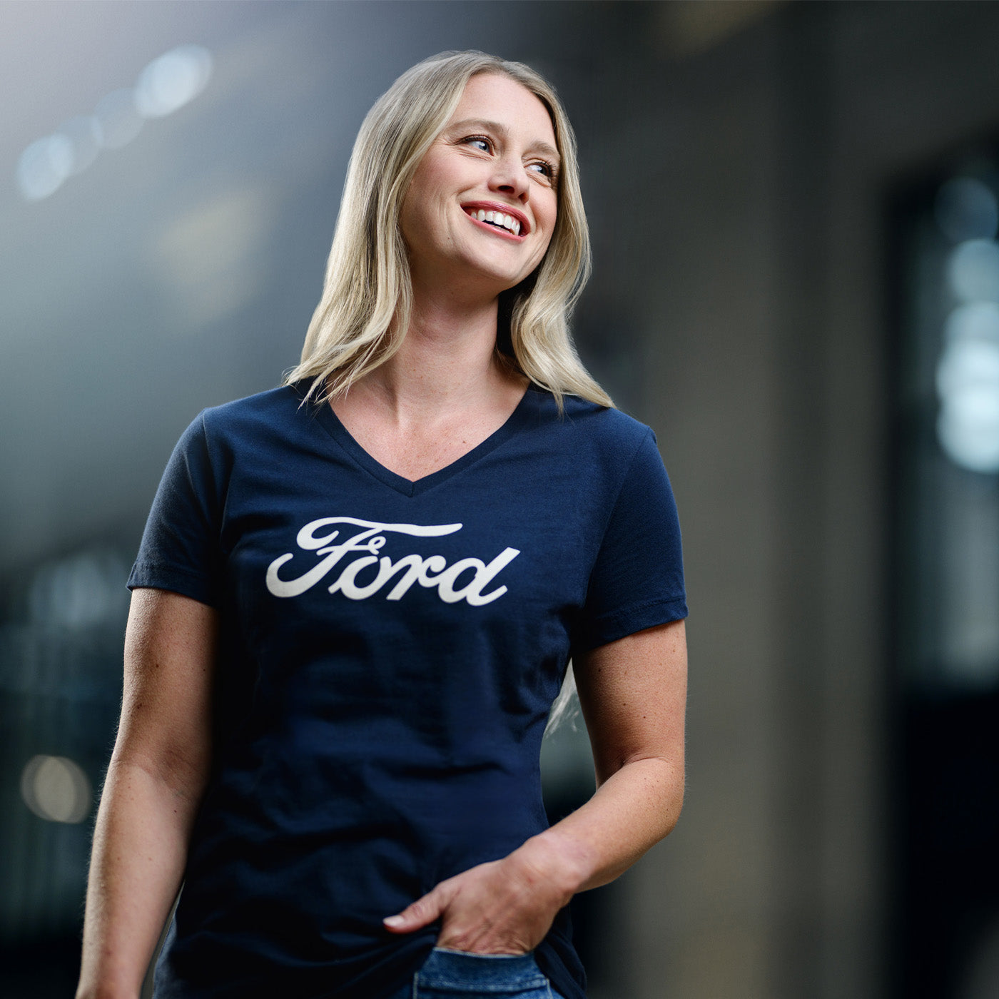 Woman wearing a navy blue Ford t-shirt with a blurred background
