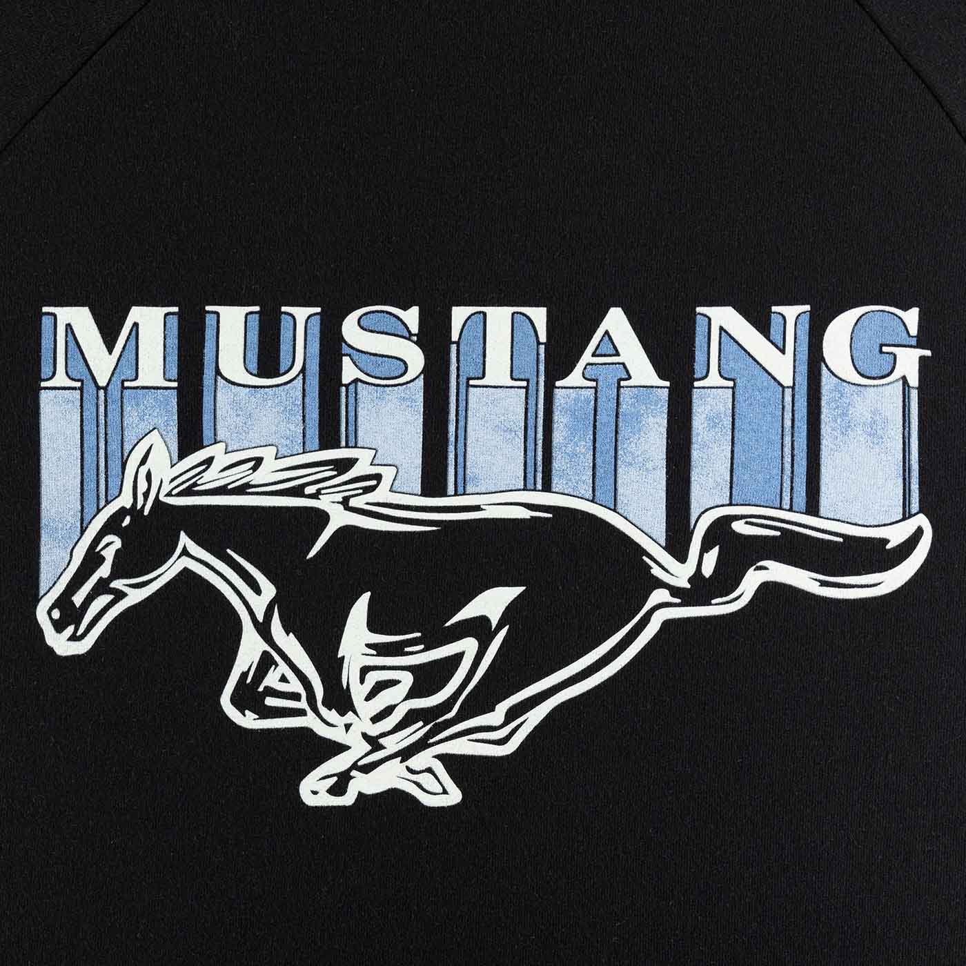 close up of blue mustang block lettering and pony logo on a black background