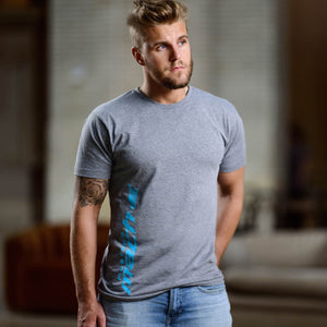 Man wearing a gray t-shirt with a blue logo in an indoor setting