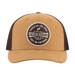 A tan and brown trucker hat with a circular embroidered patch on the front. The patch reads 'TOUGH ON THE TRAIL BRONCO 4-WHEEL DRIVE VEHICLE EASY ON THE ROAD'.