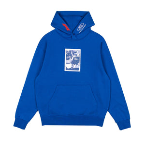 A royal blue pullover hoodie with a front kangaroo pocket and a blue-and-white graphic print on the chest. The hood features a white embroidered Ford logo on the right side and a red accent tab on the left.