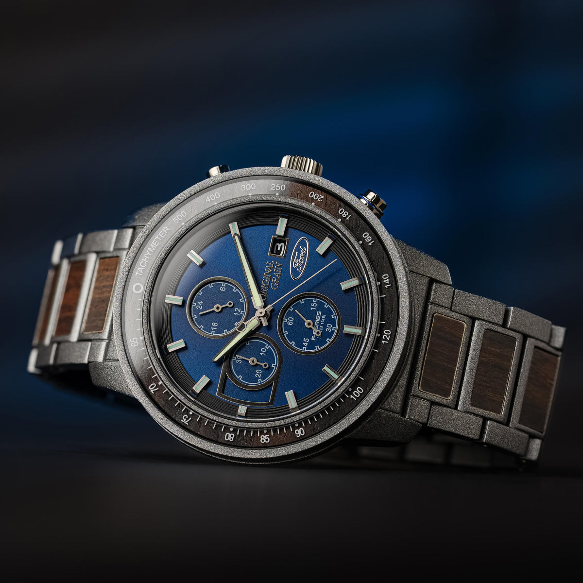 Luxury watch with a blue face and wooden strap on a dark background