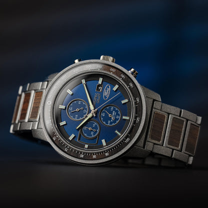 Luxury watch with a blue face and wooden strap on a dark background