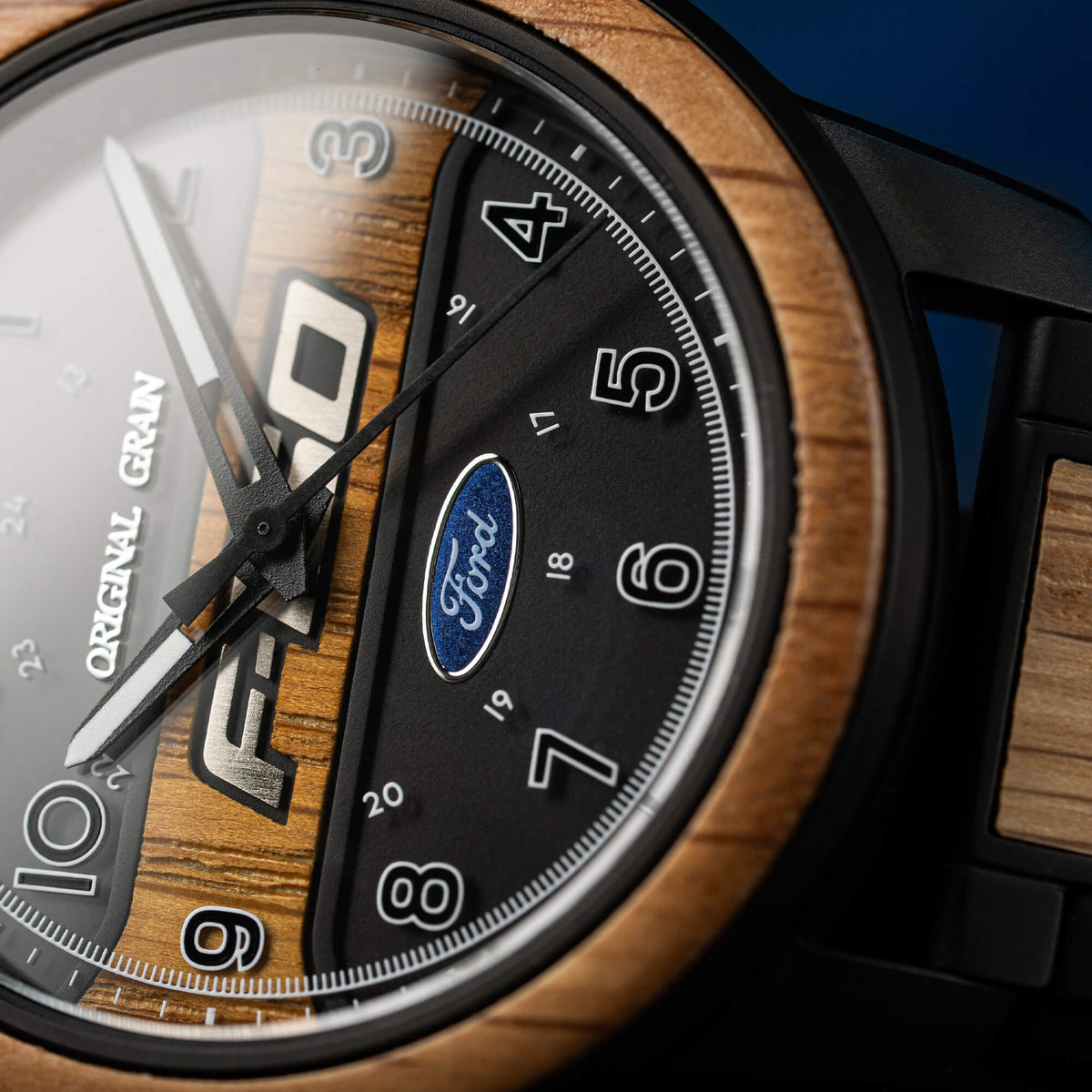 Close-up of a watch with wooden face and Ford logo