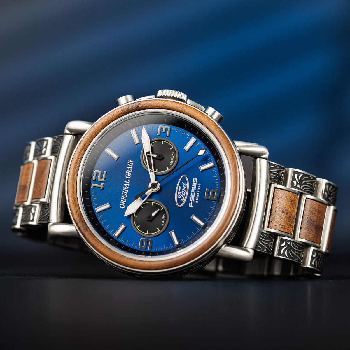 Luxury watch with wooden and metal strap on a blue gradient background