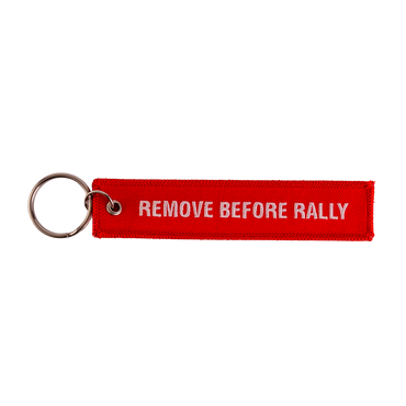 Red keychain with 'REMOVE BEFORE RALLY' text on a white background