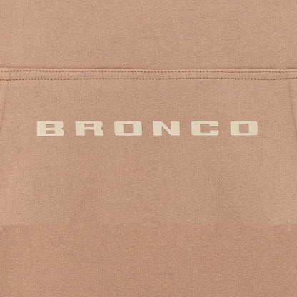 Close-up of a brown fabric surface with 'BRONCO' branding.