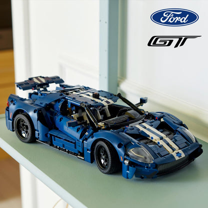 Blue and white model car on a surface with Ford logo above