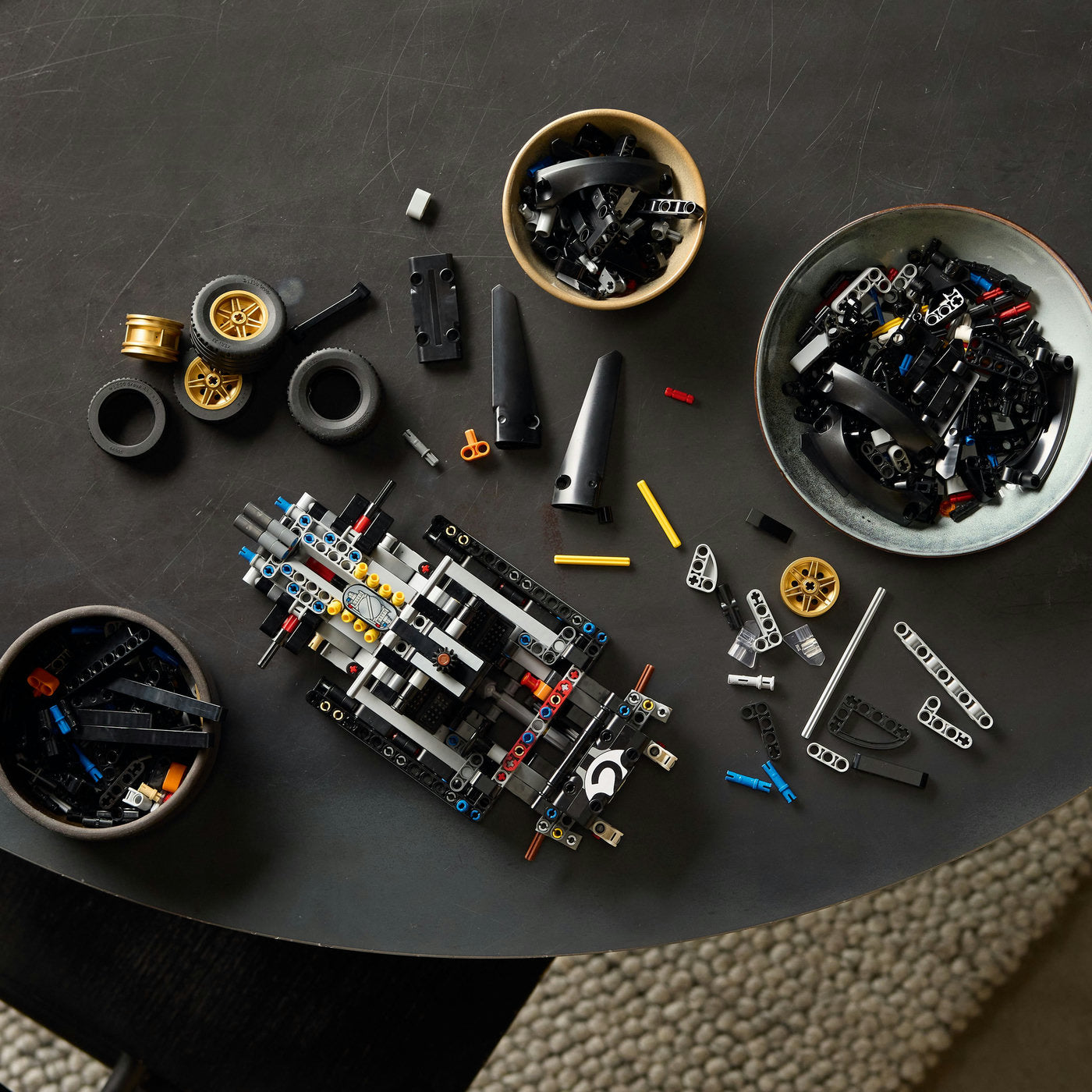 Various mechanical parts and components on a dark surface from Ford Lego technic set