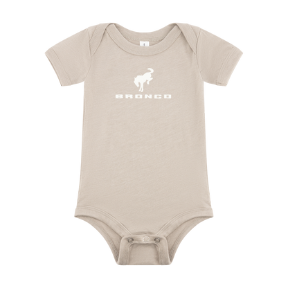 Beige baby onesie with a white Ford Bronco graphic and text on a white background