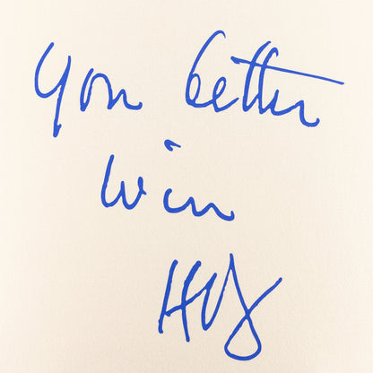 Handwritten text 'You better win' in blue ink on beige paper.