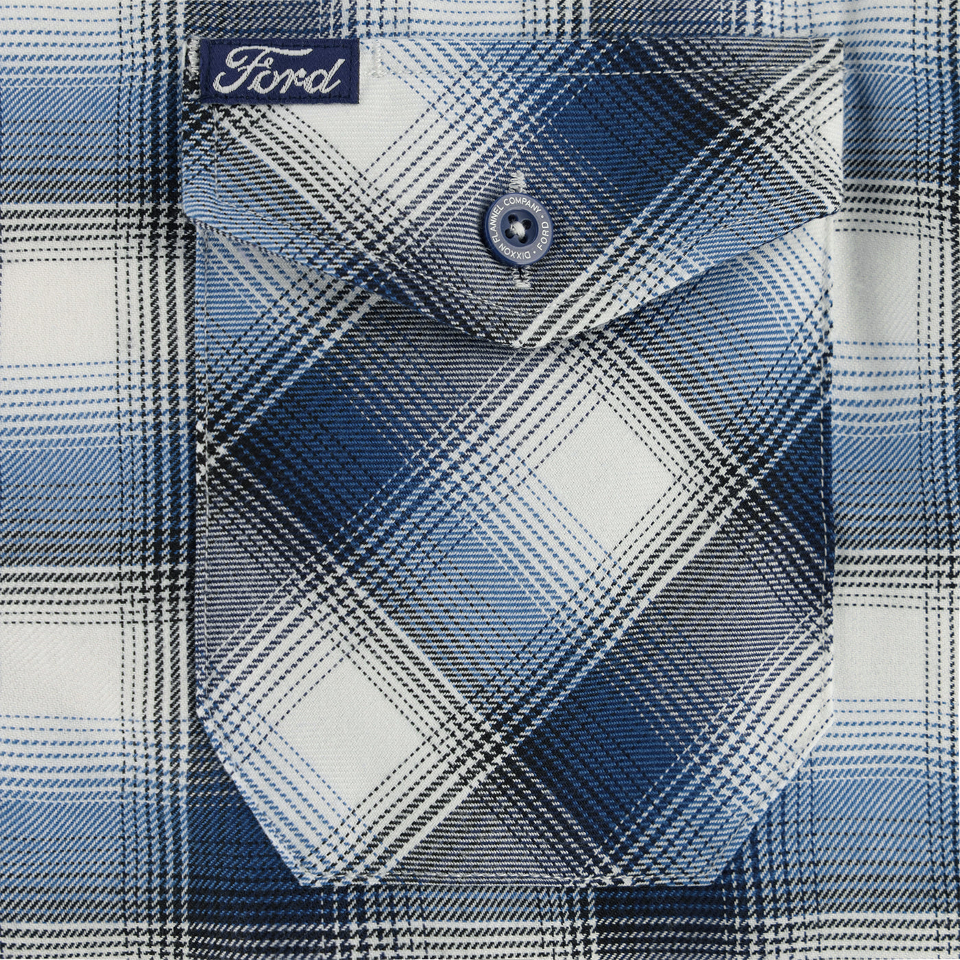 Close-up of a blue and white plaid shirt with 'Ford' branding on a button.