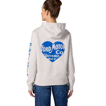 A woman shown from the back wearing a light gray hoodie with a large blue and white Ford Motor Co. heart graphic on the back and blue text down one sleeve, paired with blue jeans against a plain white background.
