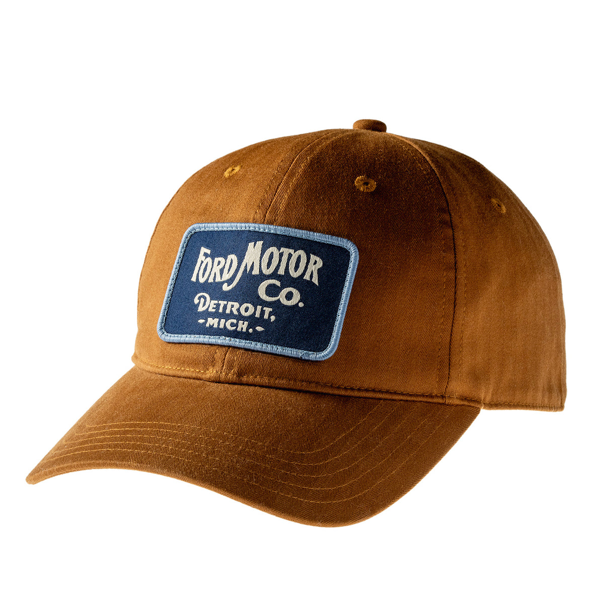 A brown canvas baseball cap featuring a blue embroidered patch on the front with the text 'Ford Motor Co. Detroit, Mich.