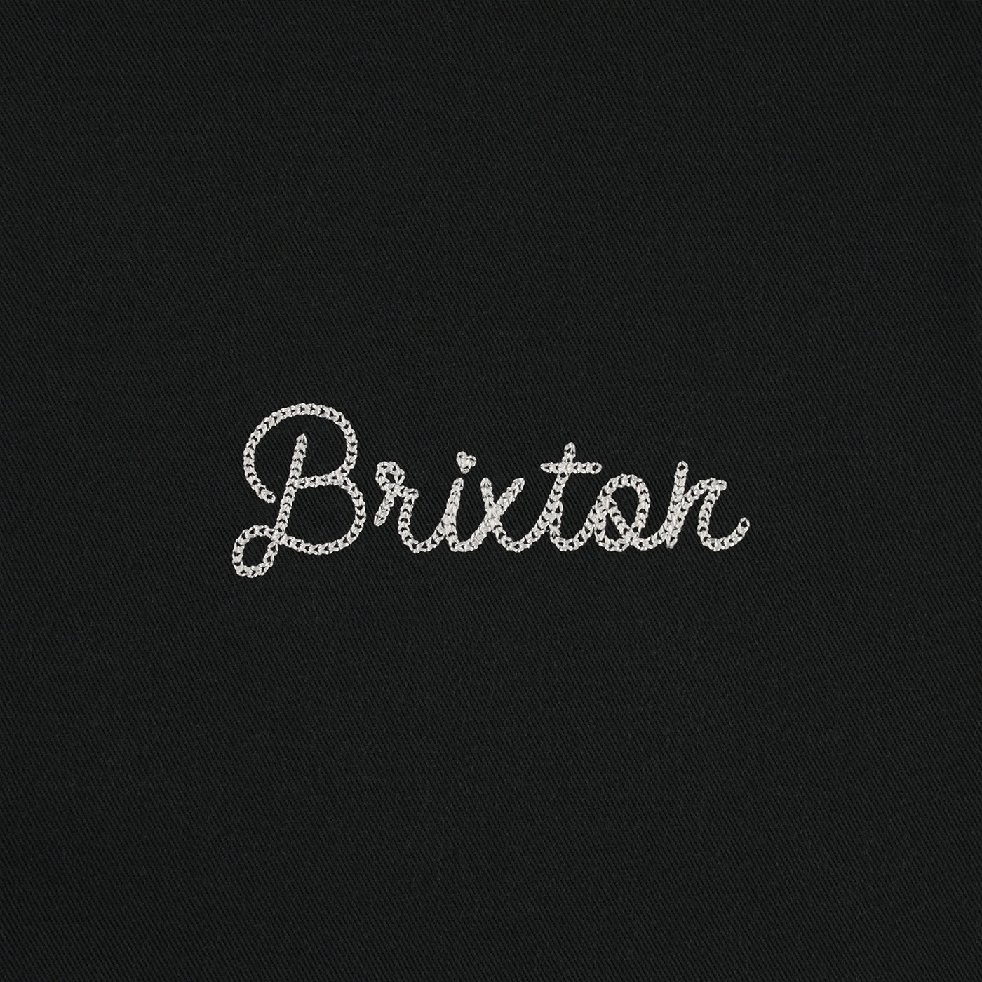 Black fabric with 'Brixton' embroidered in white