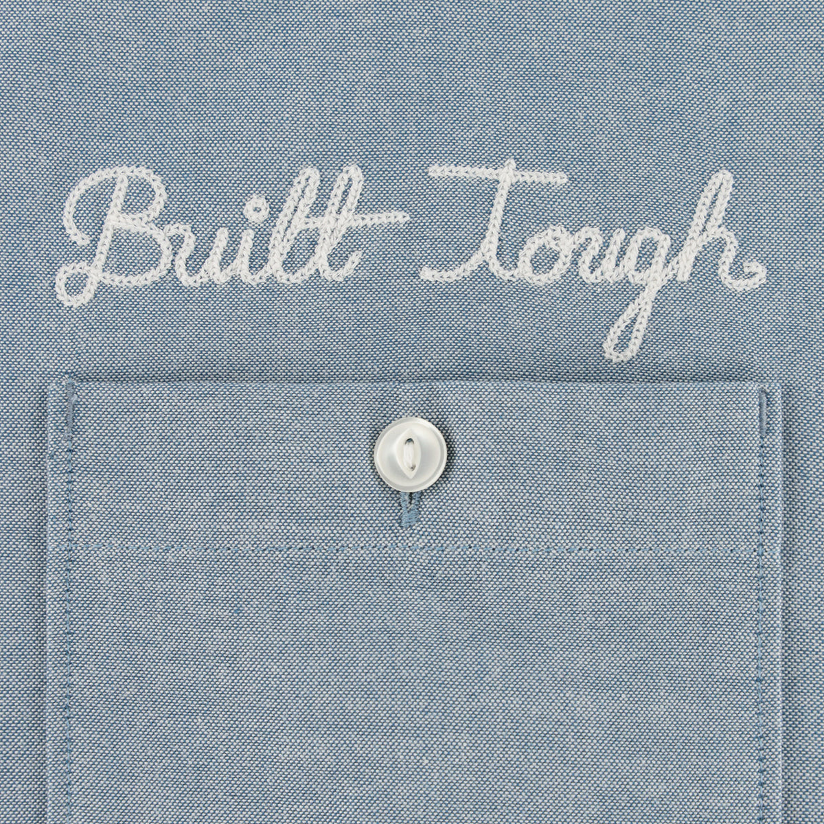 Text 'Built Tough' on a blue denim fabric background