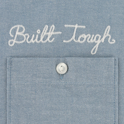 Text 'Built Tough' on a blue denim fabric background