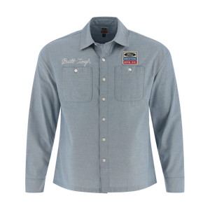 Light blue button-up shirt with embroidered text and patches on a white background