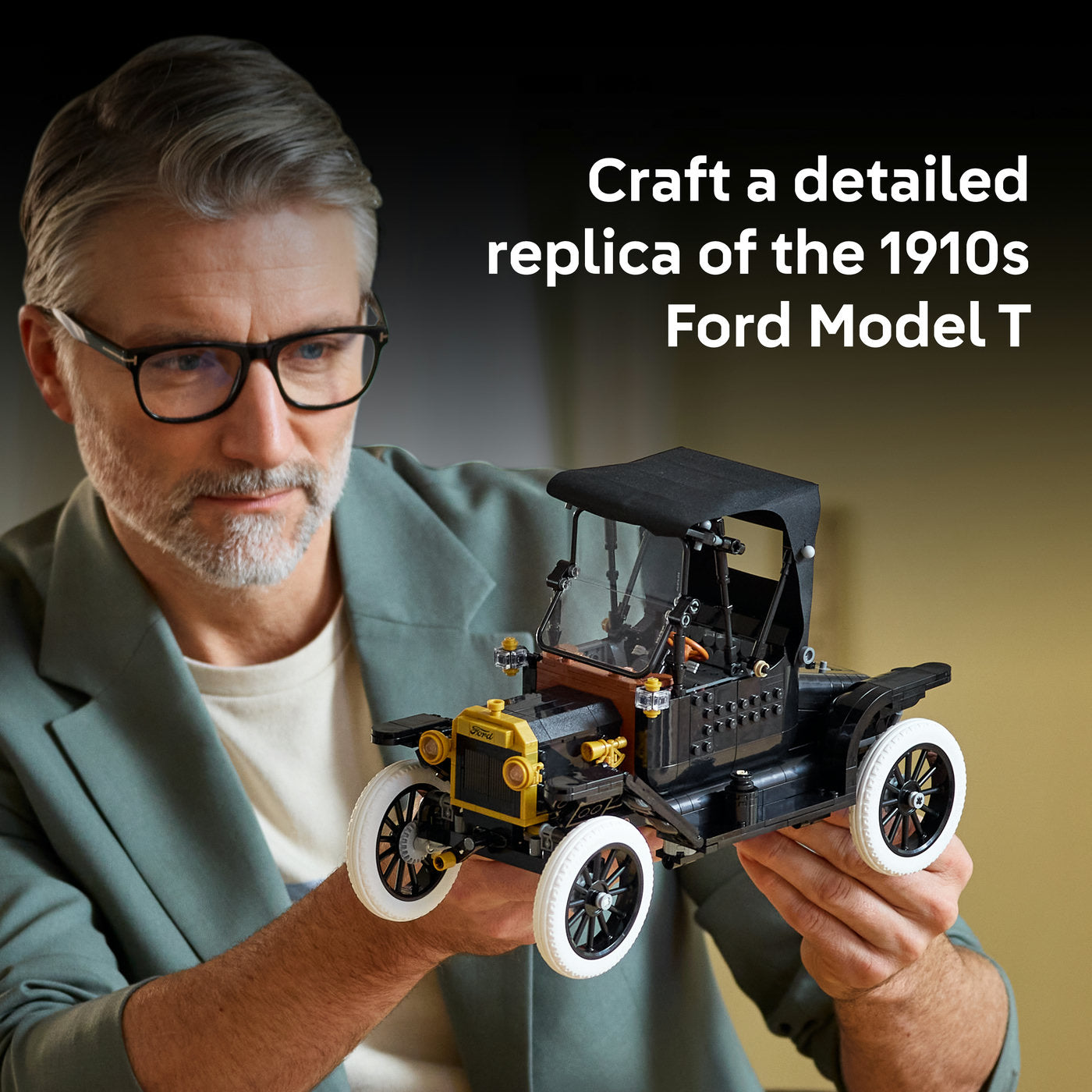 Man holding a detailed model of a 1910s Ford Model T car