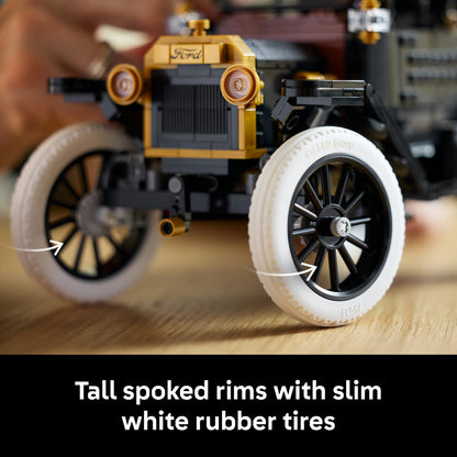 Toy car model with detailed components on a wooden surface