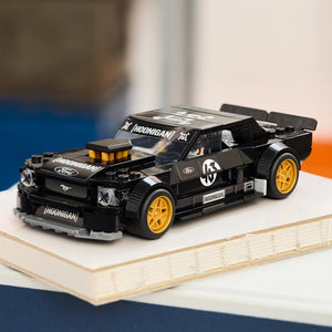 Toy car lego mustang on a wooden surface with a blurred background