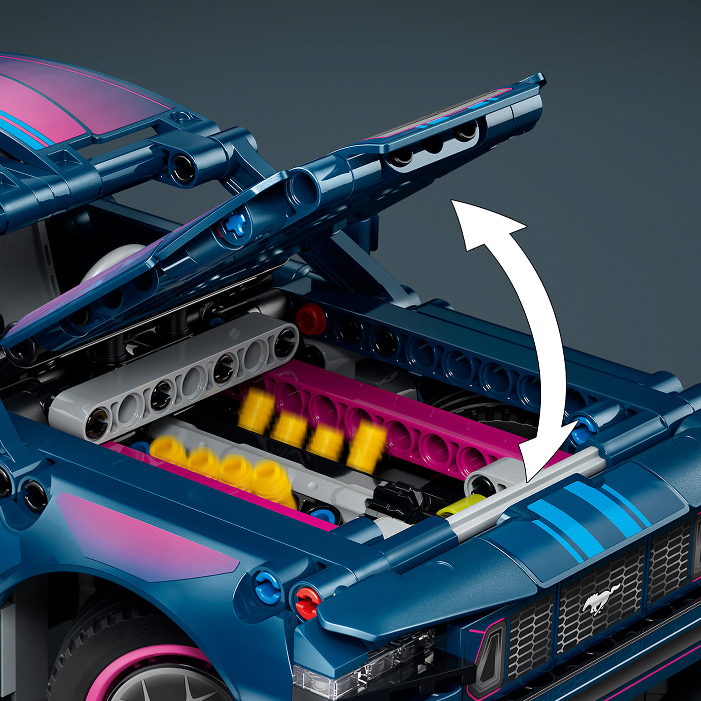 Close-up of a blue toy car with open hood showing engine details on a dark background