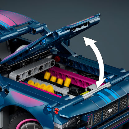 Close-up of a blue toy car with open hood showing engine details on a dark background