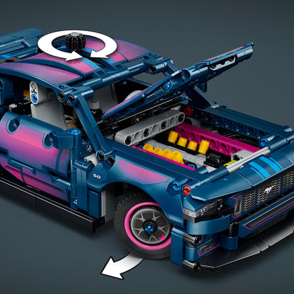 Blue and pink toy car model with open hood on a dark gray background