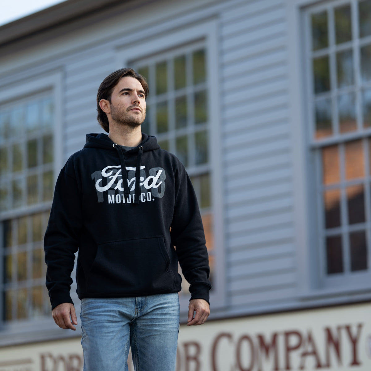 man outside wearing a black hoodie with white Ford motor co script text