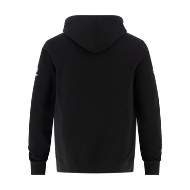 A black hooded sweatshirt shown from the back, featuring a small blue and white logo on the left sleeve, set against a plain white background.