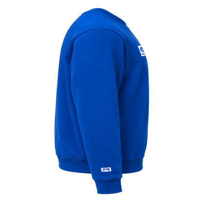A royal blue crewneck sweatshirt shown from a side profile view on a clean white background. It features a small white and blue logo patch on the upper left chest and a larger matching logo patch on the lower left sleeve cuff.
