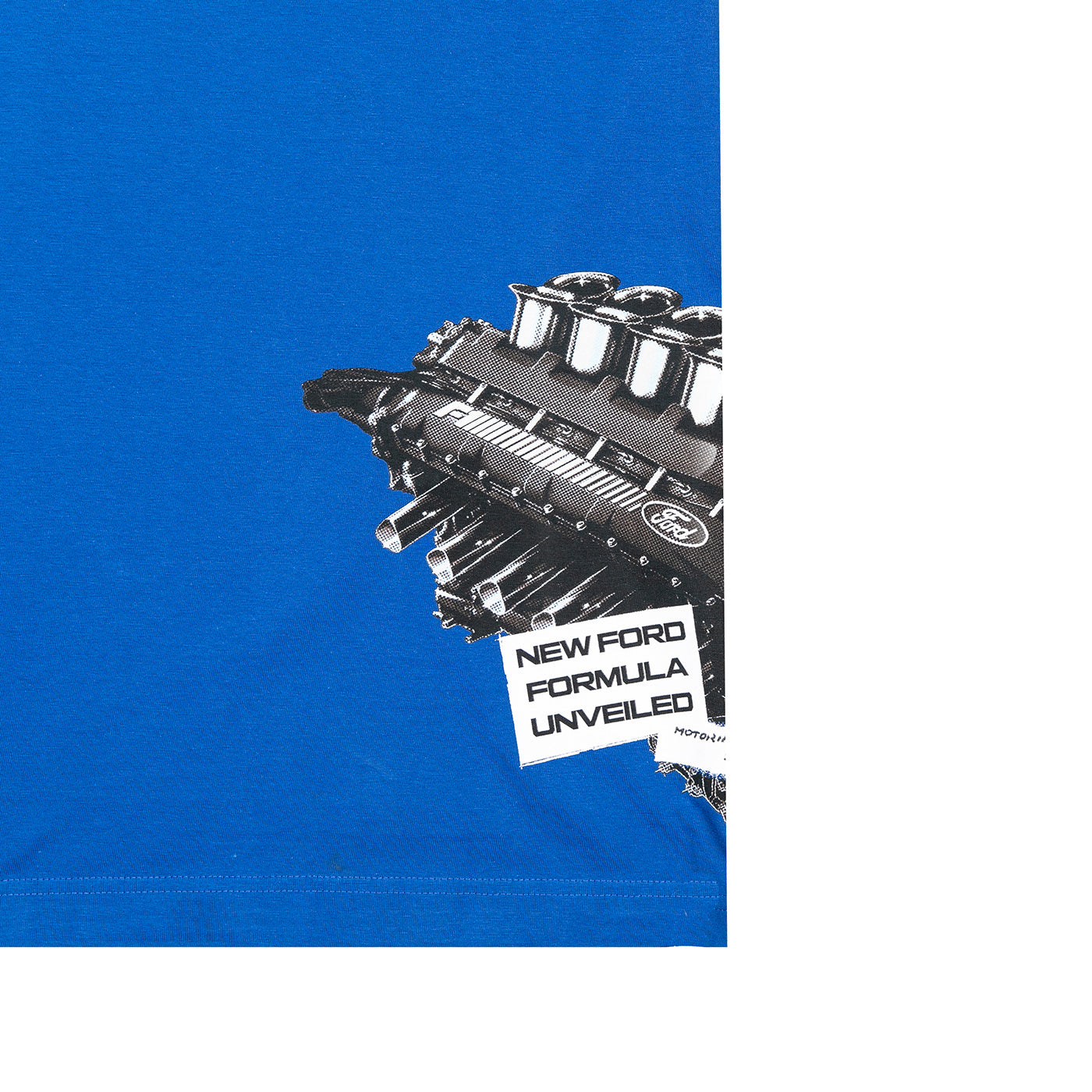 A close-up of a bright blue T-shirt with a large black-and-white engine graphic and a torn-paper style label reading 'NEW FORD FORMULA UNVEILED' on the chest.