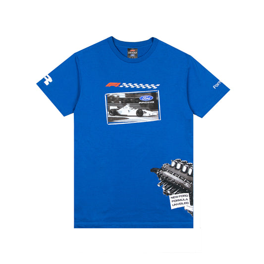 A royal blue short-sleeve t-shirt featuring a New Ford Formula 1 graphic on the chest and a detailed engine illustration on the lower right front. The shirt includes a small Ford logo on the left sleeve and a checkered flag graphic above the chest print.
