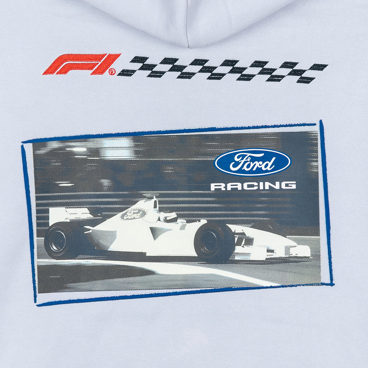 A close-up of a light gray garment featuring a printed F1 racing graphic. The design includes a red and black F1 logo above a rectangular print of a white Ford racing car with the blue Ford Racing logo and a blue border.